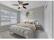 Cozy bedroom with a ceiling fan, a comfortable bed, and a bright window at 6665 Boxcar Pl, Indianapolis, IN 46220