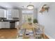 Charming dining area with hardwood floors, stylish table, and natural light from the windows at 6665 Boxcar Pl, Indianapolis, IN 46220