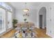 Bright dining area with seating for six, modern lighting, and a view to the outdoors at 6665 Boxcar Pl, Indianapolis, IN 46220