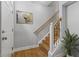 Inviting entryway with hardwood floors, staircase, and artwork on the wall at 6665 Boxcar Pl, Indianapolis, IN 46220