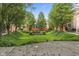 The lush, grassy setting with mature trees and manicured bushes is the perfect retreat from city life at 6665 Boxcar Pl, Indianapolis, IN 46220