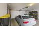 Attached garage with shelving and storage plus a newer car, providing parking and storage at 6665 Boxcar Pl, Indianapolis, IN 46220