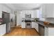 Well-equipped kitchen with stainless steel appliances, granite countertops, and wooden floors at 6665 Boxcar Pl, Indianapolis, IN 46220