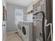 Functional laundry room with washer, dryer, and storage shelves for added convenience at 6665 Boxcar Pl, Indianapolis, IN 46220