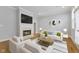 Bright living room featuring a fireplace with a TV, comfortable seating, and stylish décor at 6665 Boxcar Pl, Indianapolis, IN 46220
