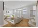 Open-concept living room with a staircase, large windows, and hardwood floors at 6665 Boxcar Pl, Indianapolis, IN 46220