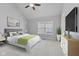Serene bedroom featuring a large window and a bed with decorative pillows at 6665 Boxcar Pl, Indianapolis, IN 46220