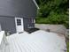 Inviting backyard deck with white railings, gray floorboards and an excellent view at 689 N Main St, Martinsville, IN 46151