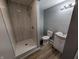 Bright bathroom features a tiled walk-in shower and a modern vanity with storage at 689 N Main St, Martinsville, IN 46151