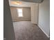 Bedroom showing neutral walls, window and carpeted flooring at 689 N Main St, Martinsville, IN 46151