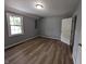 Bedroom showcasing wood-look flooring and a bright window at 689 N Main St, Martinsville, IN 46151