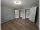 Bright bedroom features wood-look flooring and spacious closets at 689 N Main St, Martinsville, IN 46151