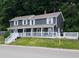 Charming two-story home features a welcoming front porch and beautifully landscaped yard at 689 N Main St, Martinsville, IN 46151