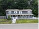 Charming two-story home features a welcoming front porch and beautifully landscaped yard at 689 N Main St, Martinsville, IN 46151