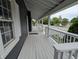 Inviting front porch with white railing, gray floorboards and an excellent view at 689 N Main St, Martinsville, IN 46151