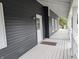 Inviting front porch with white railing, gray floorboards and an excellent view at 689 N Main St, Martinsville, IN 46151