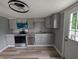 Modern kitchen with stainless steel appliances, gray cabinets and hardwood floors at 689 N Main St, Martinsville, IN 46151