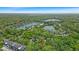 Breathtaking aerial view of lakeside condos surrounded by lush greenery and mature trees offering serene views at 6916 Ralph Ct, Indianapolis, IN 46220