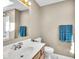 Functional bathroom featuring a vanity with a sink and a shower with blue towels at 6916 Ralph Ct, Indianapolis, IN 46220