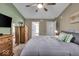 Cozy bedroom featuring neutral tones, a ceiling fan, and ample natural light at 6916 Ralph Ct, Indianapolis, IN 46220