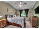 Comfortable bedroom with a large window, ceiling fan, and cozy furnishings at 6916 Ralph Ct, Indianapolis, IN 46220