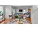 Open-concept dining area flowing into the living room, featuring hardwood floors and plenty of natural light at 6916 Ralph Ct, Indianapolis, IN 46220