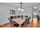 Well-lit dining room with stylish lighting and plenty of seating at 6916 Ralph Ct, Indianapolis, IN 46220