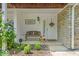 Inviting front porch with stone accents, bench seating, and charming floral decor, offering a warm welcome at 6916 Ralph Ct, Indianapolis, IN 46220