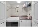 Efficient laundry room with white appliances and convenient shelving at 6916 Ralph Ct, Indianapolis, IN 46220