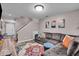 Comfortable living room with a sectional, colorful rug and stairway access to the second level at 6916 Ralph Ct, Indianapolis, IN 46220