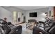 Comfortable living room with hardwood floors, modern furniture, and access to a private balcony at 6916 Ralph Ct, Indianapolis, IN 46220