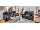 Cozy living room with hardwood floors, comfortable seating, and a staircase leading to the upper level at 6916 Ralph Ct, Indianapolis, IN 46220