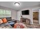 Relaxing living room with a sectional, media center and a view into an adjacent study or den at 6916 Ralph Ct, Indianapolis, IN 46220