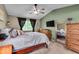 Serene main bedroom with a ceiling fan, dresser and a view of the room in the full length mirror at 6916 Ralph Ct, Indianapolis, IN 46220
