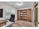 Functional home office with a sliding barn door style bookcase and natural light from the window at 6916 Ralph Ct, Indianapolis, IN 46220