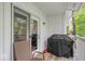 Relaxing patio space, complete with an outdoor chair, a grill, and views of the surrounding greenery at 6916 Ralph Ct, Indianapolis, IN 46220
