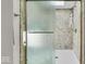 Clean shower with textured glass door and tiled walls at 6916 Ralph Ct, Indianapolis, IN 46220