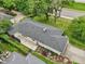 Aerial view of single story home with black roof and an outdoor patio area, surrounded by landscaping at 7277 N College Ave, Indianapolis, IN 46240