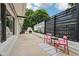 Back patio with outdoor seating, black privacy screening, and brick fireplace at 7277 N College Ave, Indianapolis, IN 46240