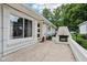 Back patio with brick fireplace, privacy fence, and access to the home at 7277 N College Ave, Indianapolis, IN 46240