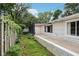 Landscaped yard with privacy fence, back patio and colorful flower bed at 7277 N College Ave, Indianapolis, IN 46240