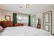 Bedroom featuring hardwood floors, neutral walls, and views to the backyard at 7277 N College Ave, Indianapolis, IN 46240