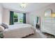 Bright bedroom with a large window, hardwood floors, and neutral decor at 7277 N College Ave, Indianapolis, IN 46240