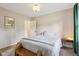 Bright bedroom featuring hardwood floors, neutral decor and a window overlooking the backyard at 7277 N College Ave, Indianapolis, IN 46240