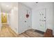 Bright foyer with a decorative front door, wood floors, and hallway at 7277 N College Ave, Indianapolis, IN 46240