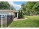 Charming single story home showcasing the landscaped front yard and a striking dark blue front door at 7277 N College Ave, Indianapolis, IN 46240