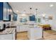 The gourmet kitchen boasts blue cabinets, granite countertops, an island, and stainless steel appliances at 7277 N College Ave, Indianapolis, IN 46240