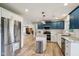 Updated kitchen with white and blue cabinets, stainless steel appliances, and granite countertops at 7277 N College Ave, Indianapolis, IN 46240