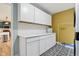 Laundry room featuring white cabinets, countertop, and tile backsplash, and patterned flooring at 7277 N College Ave, Indianapolis, IN 46240