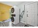 Efficient laundry room featuring stacked washer and dryer and stylish patterned flooring at 7277 N College Ave, Indianapolis, IN 46240
